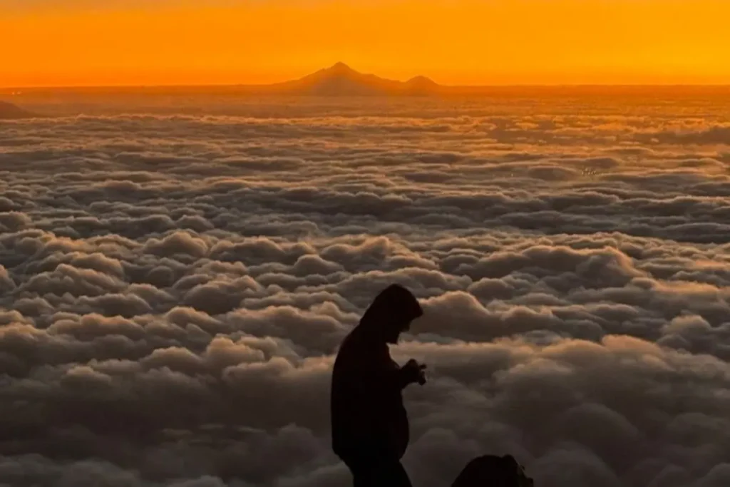 Hiker on the Iztaccihuatl summit trail above the clouds in Mexico