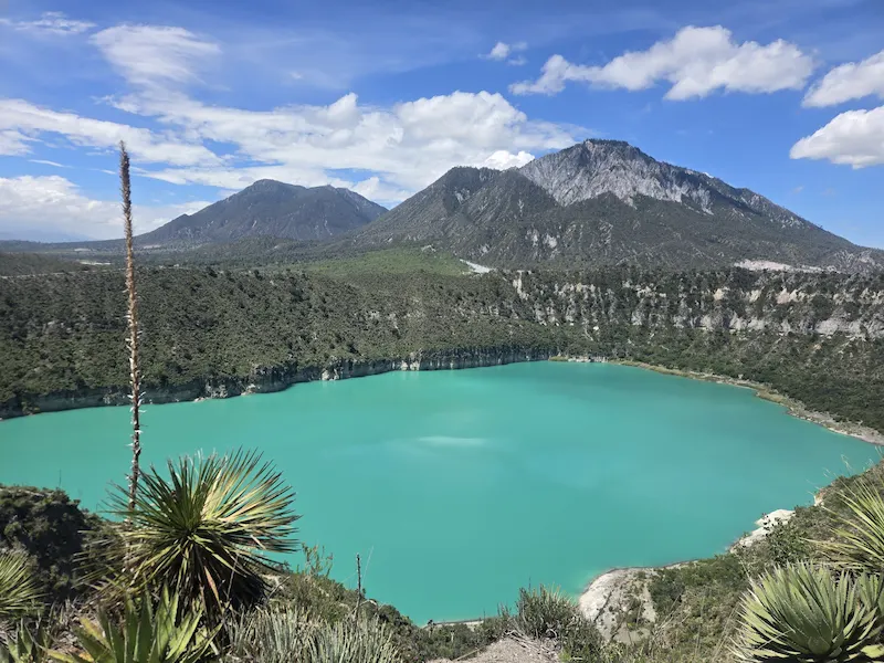 Scenic crater lake in Cantona surrounded by mountains, part of Nature and Culture Tours in Puebla, Mexico